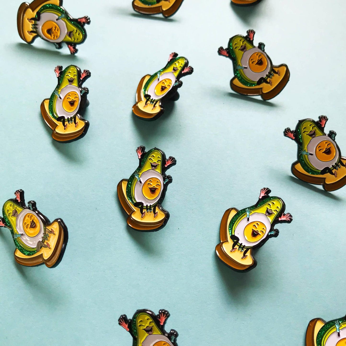 Avocado-themed pins on a light blue background