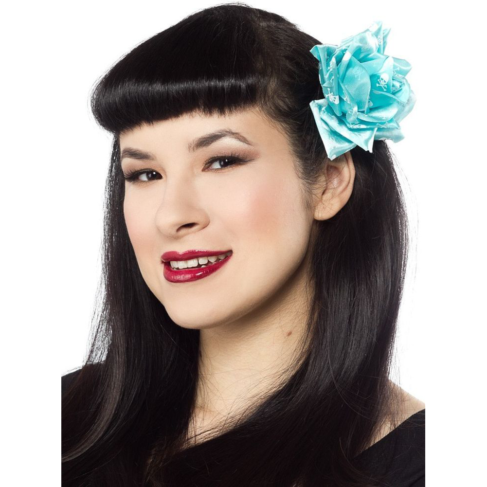 Woman with black hair and a blue flower accessory on a white background