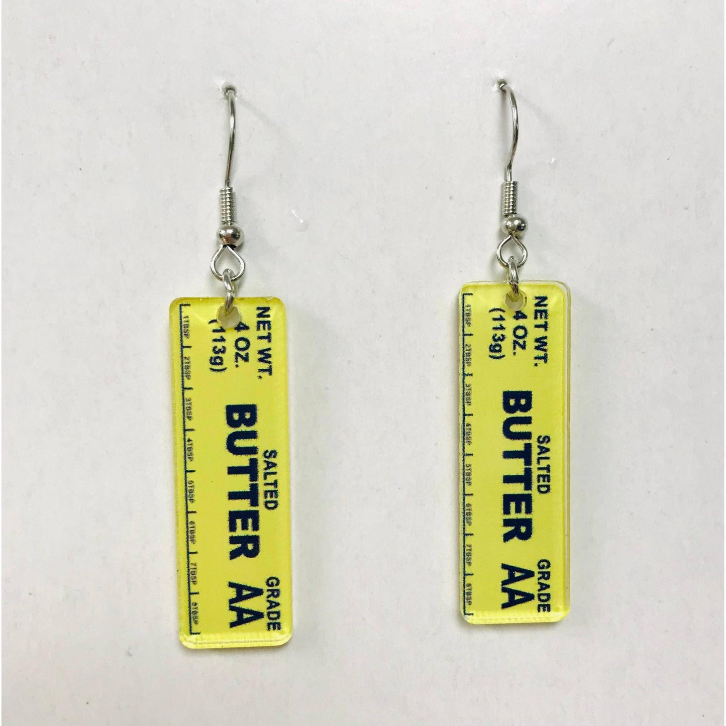 Butter container label earrings on a white background