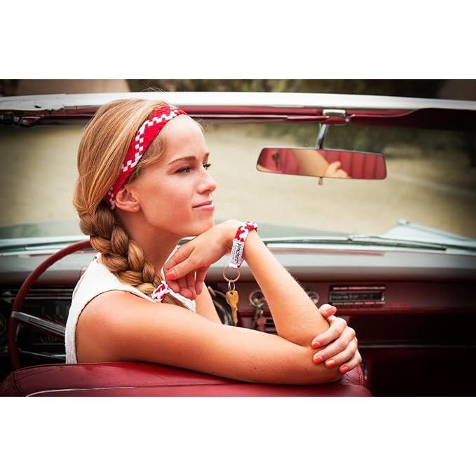 Woman sitting in a vintage car with a red interior