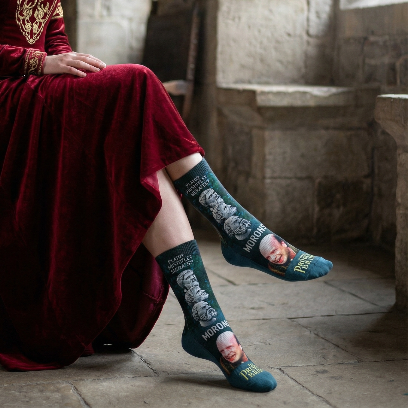 Woman in a red dress sitting on a wooden stool in a stone-walled room.
