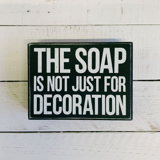 The Soap Is Not Just For Decoration Box Sign in Black with White Lettering