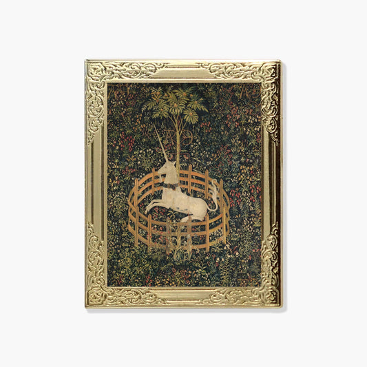 Lapel pin of a decorative tapestry with a unicorn in a gold frame 
