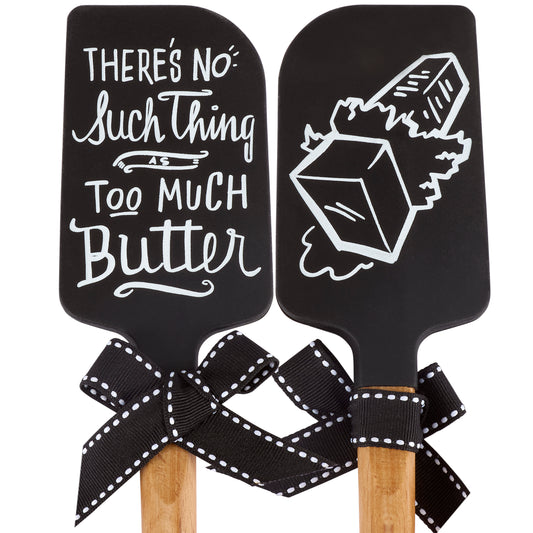 Two black spatulas with butter design, decorative handles and text on a white background