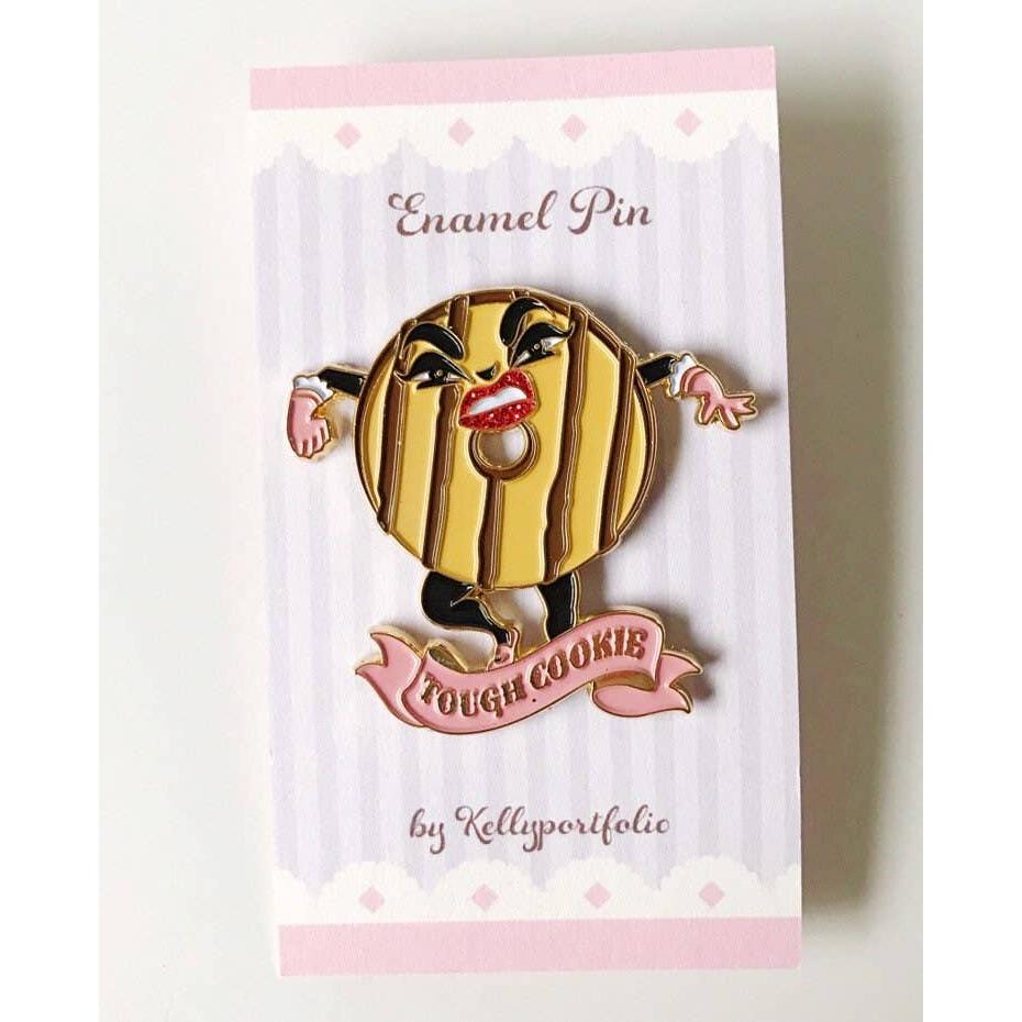 Enamel pin of a cookie character on a branded card