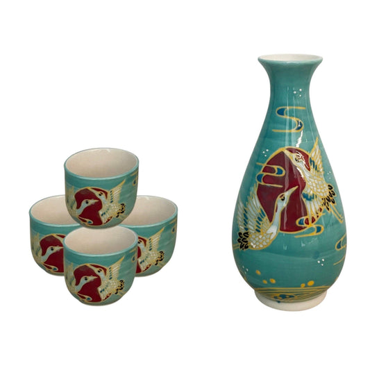 A turquoise ceramic sake set, featuring a tall sake bottle and four small cups decorated with red cranes and gold accents.
