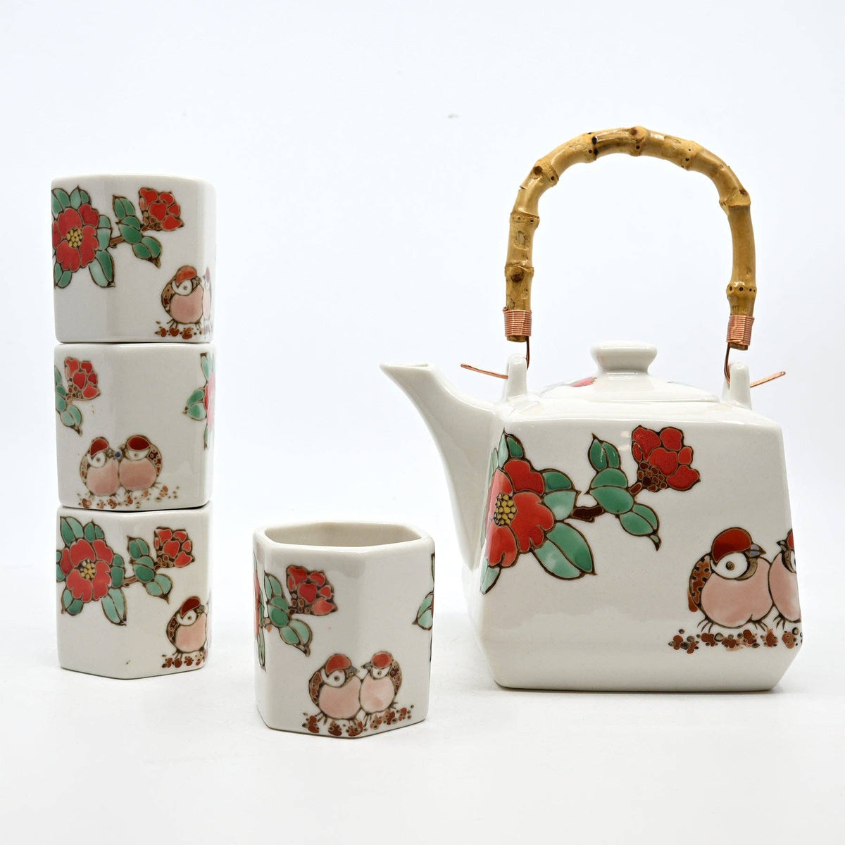 Ceramic teapot and cups with floral and bird designs