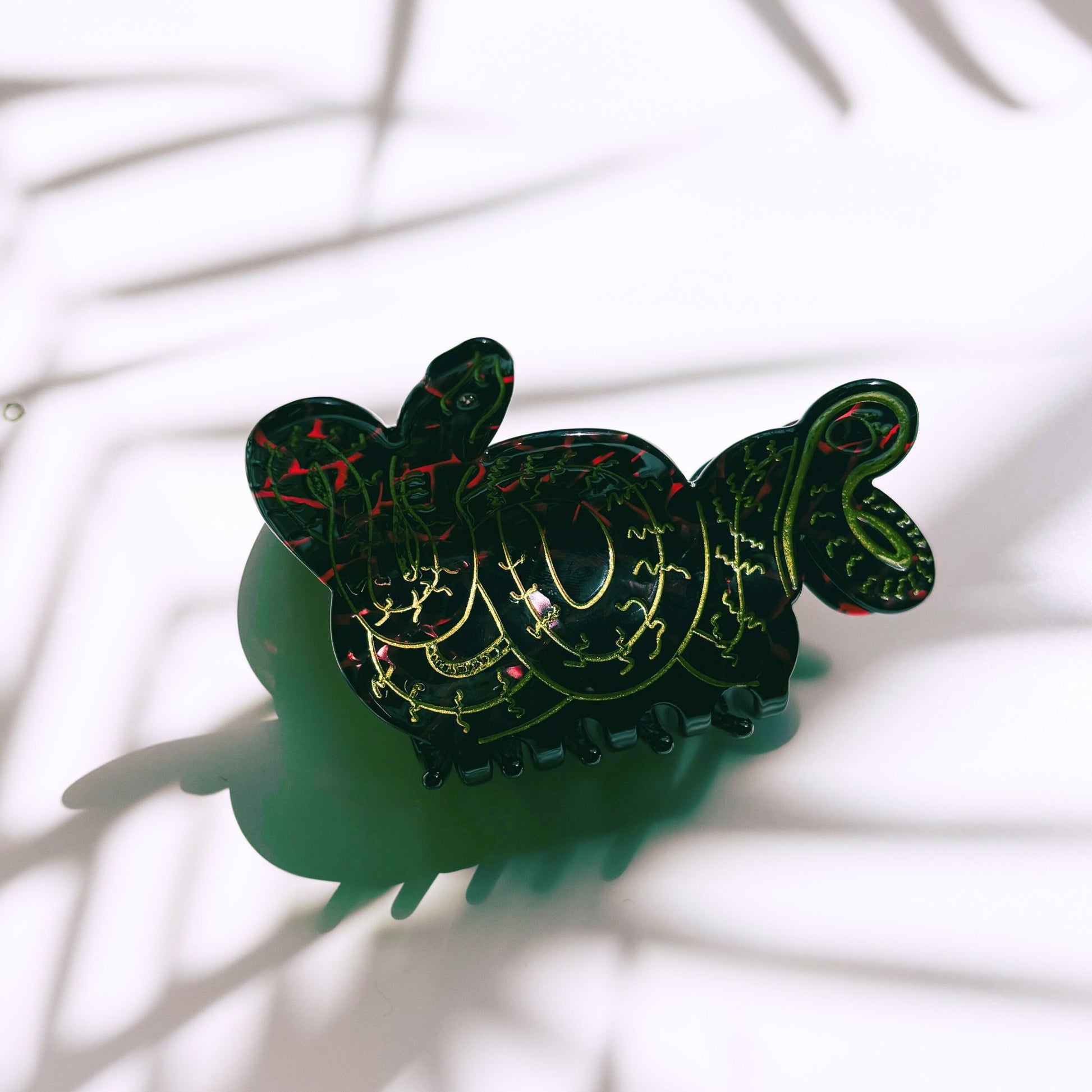 Decorative hair clip with intricate design on a white background