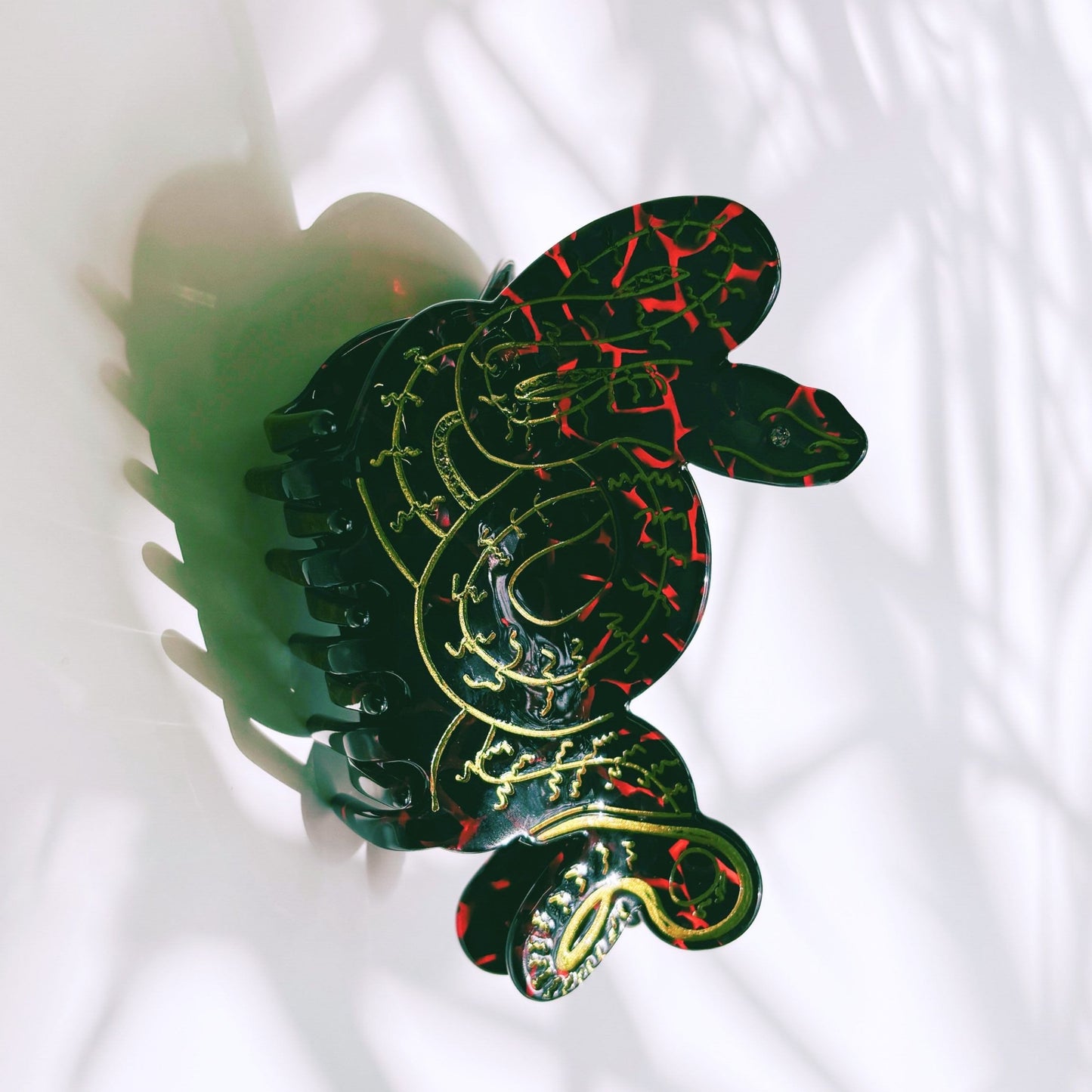 Decorative hair clip with snake design on a white background