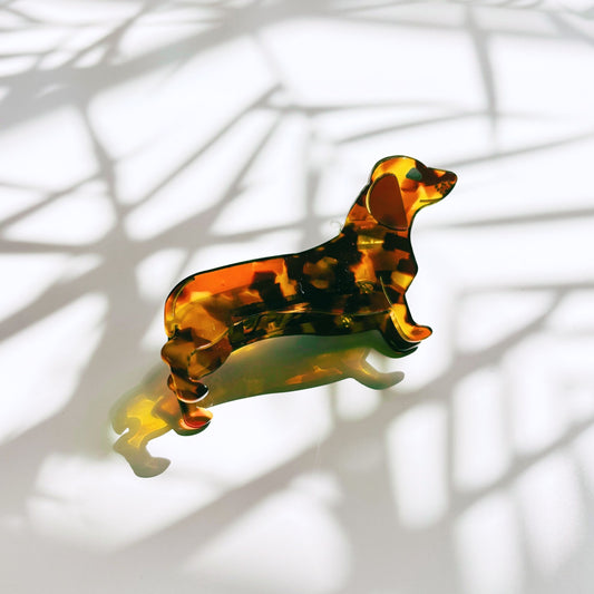 Tortoiseshell dachshund-shaped object on a white background