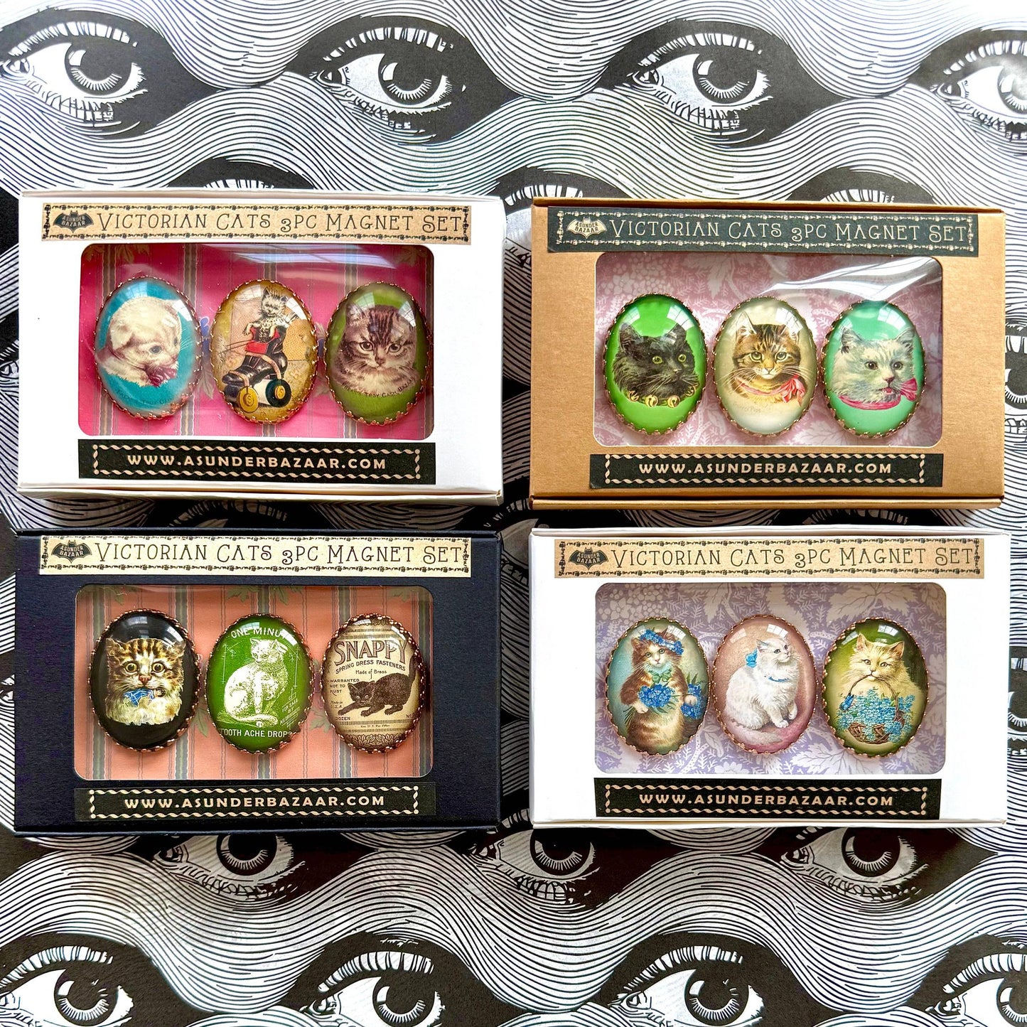 Four boxes of Victorian Cats & Co. magnet sets with decorative packaging.