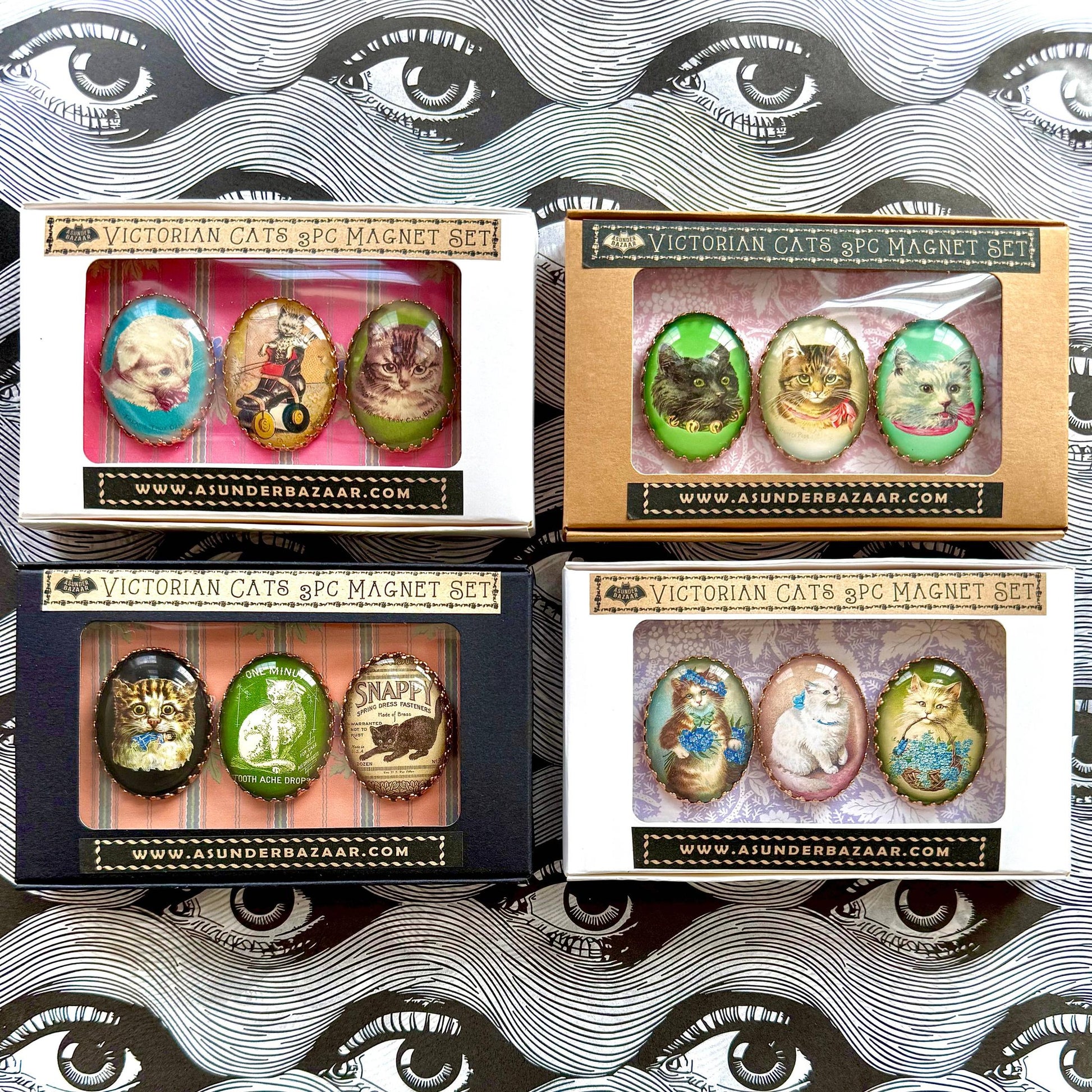 Four boxes of Victorian Cats & Co. magnet sets with decorative packaging.