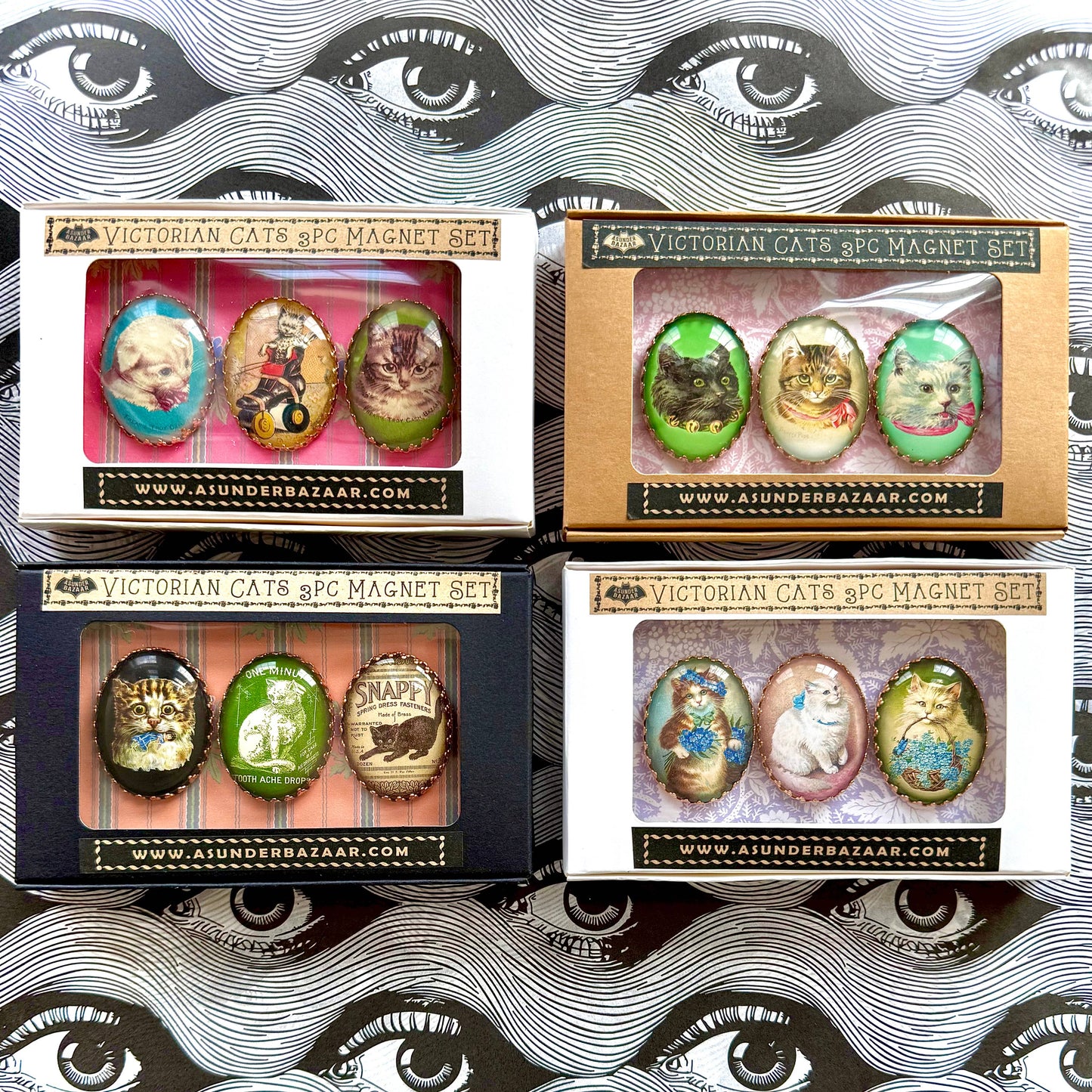 Four boxes of Victorian Cats & Co. magnet sets with decorative packaging.