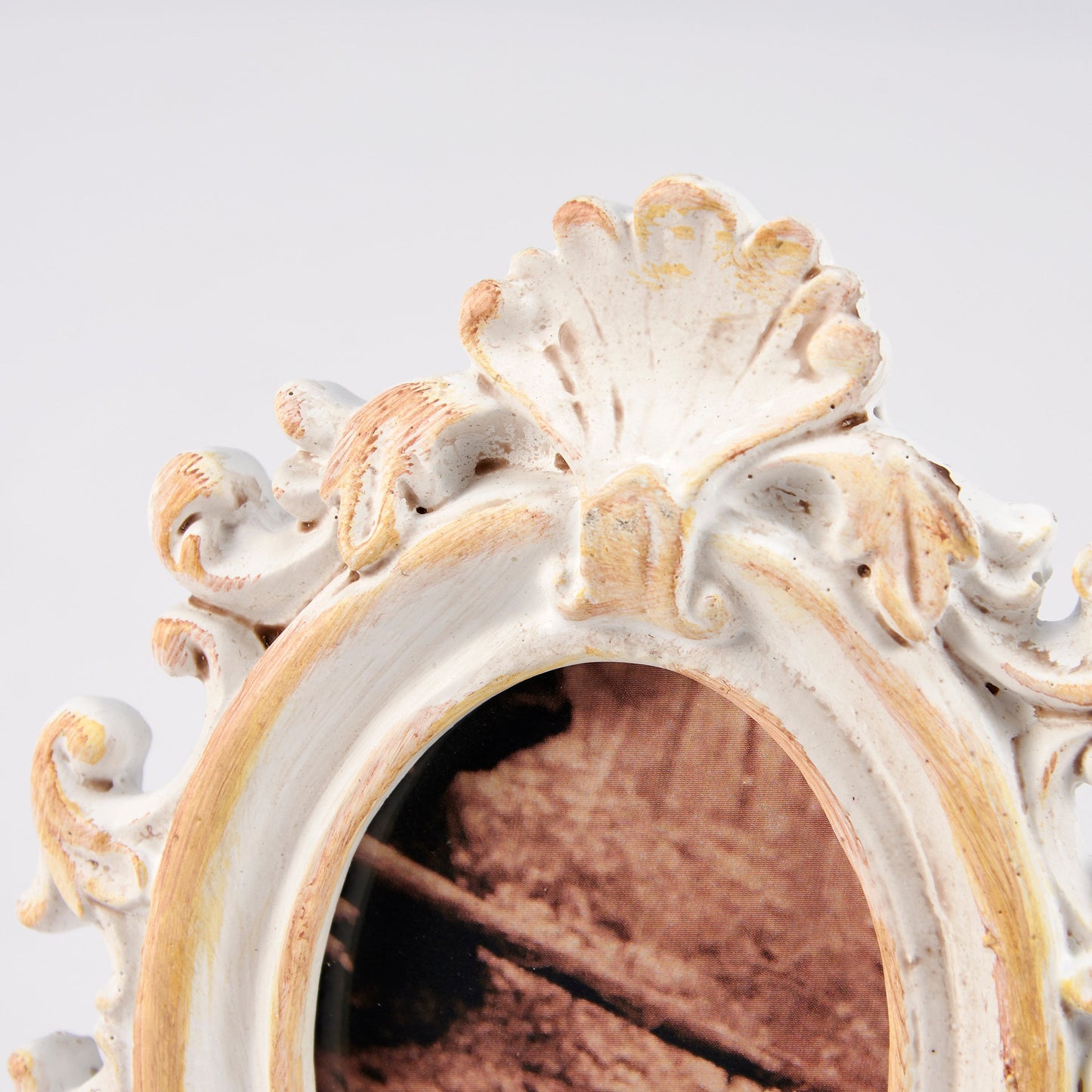 Decorative picture frame with intricate cream frame