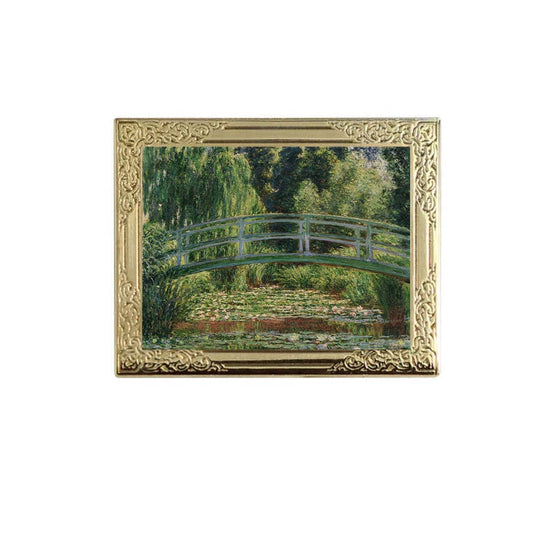 Lapel pin of framed painting of a bridge over water lilies with a gold frame