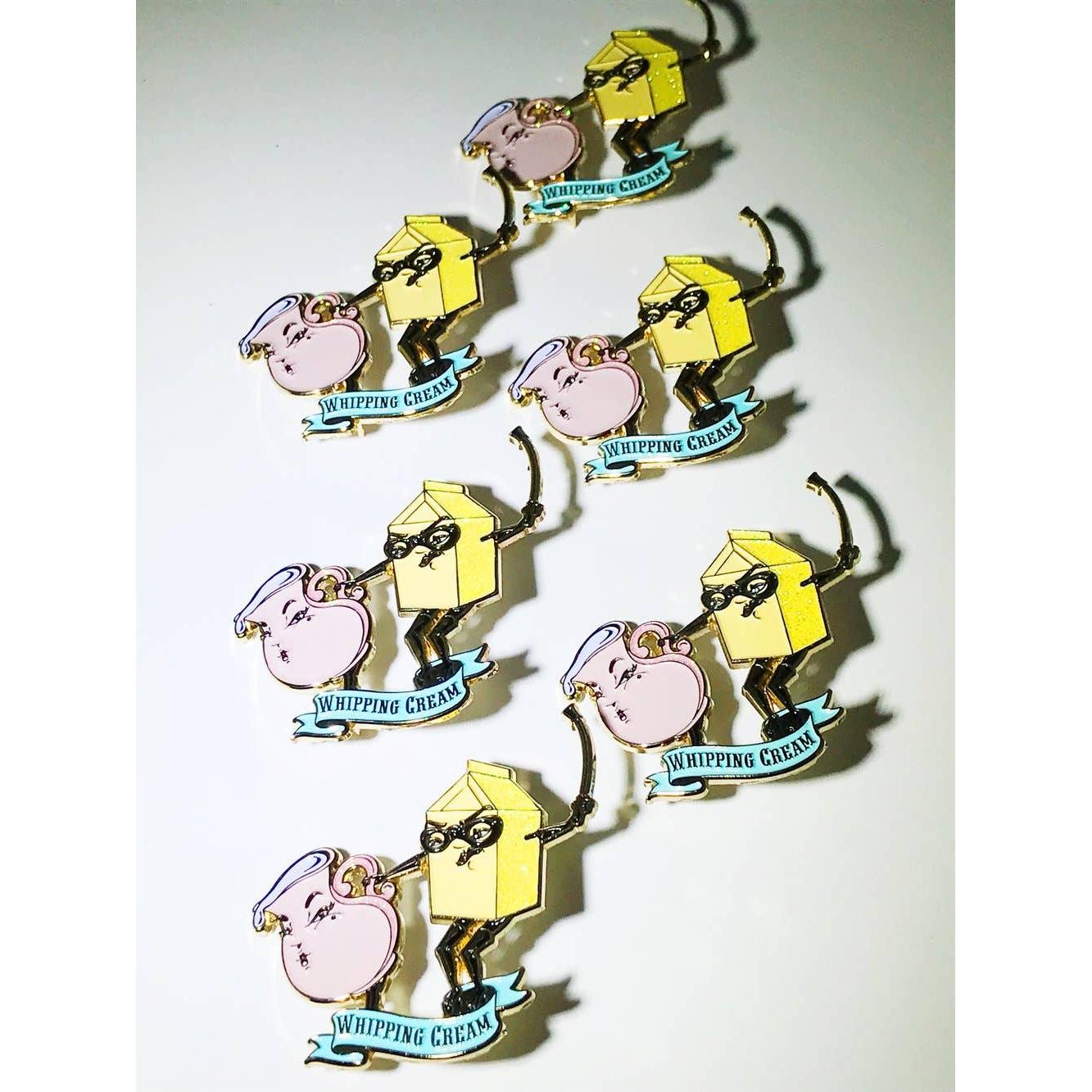 Set of 'Whipping Cream' themed pins on a white background