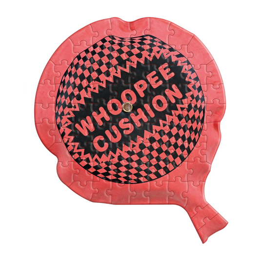 Jigsaw puzzle shaped like a whoopee cushion with red and black design on a white background