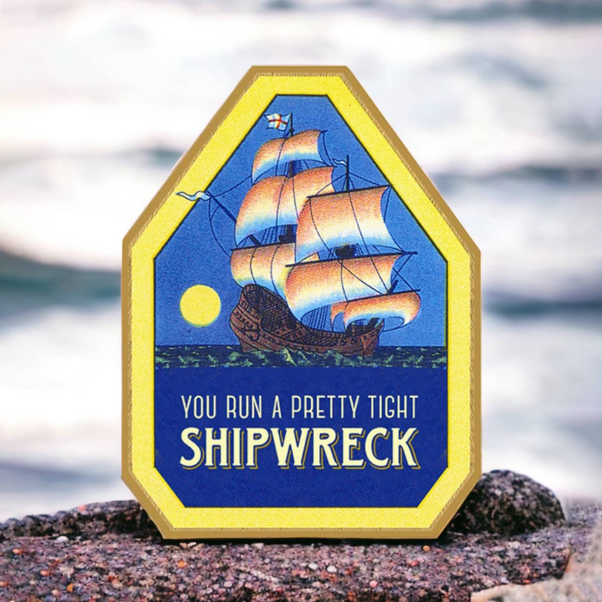 Decorative sign with a shipwreck design and text on a beach background