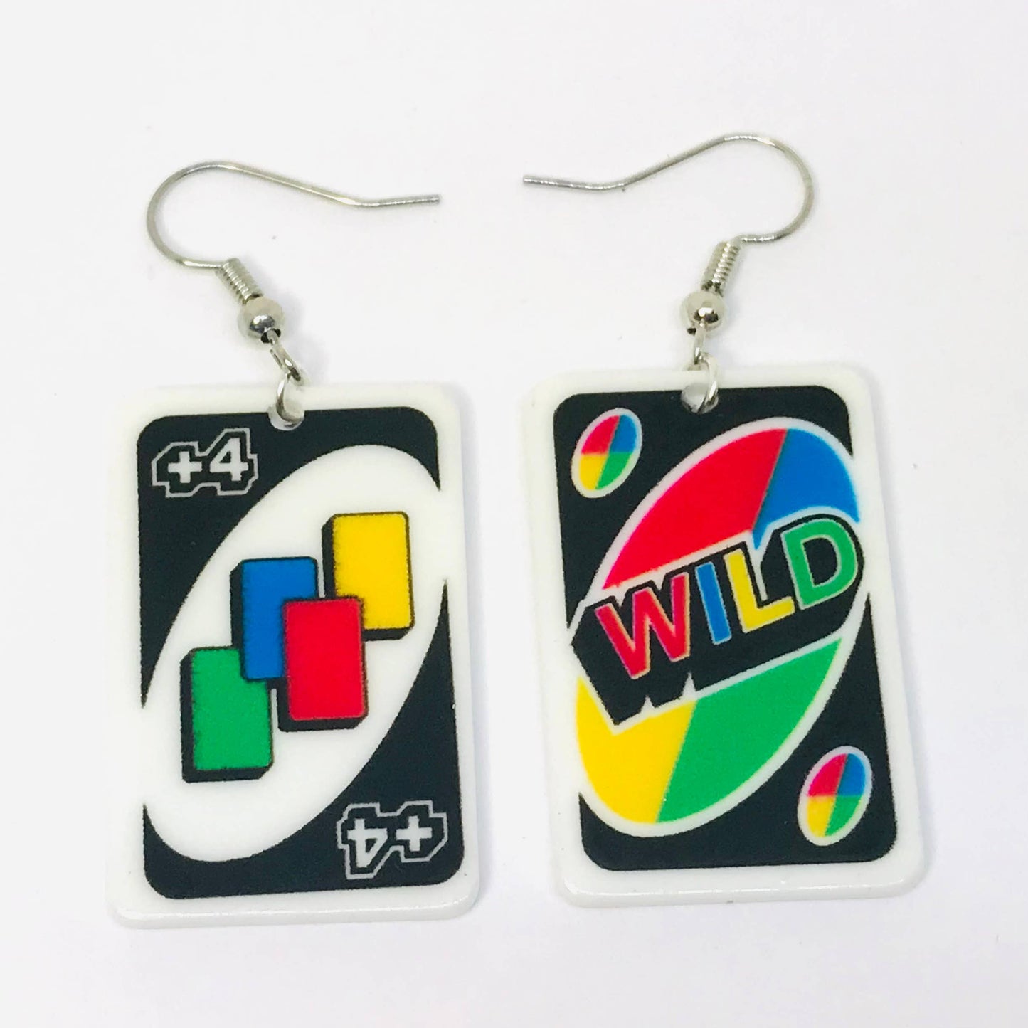 Pair of earrings designed like card game pieces on a white background