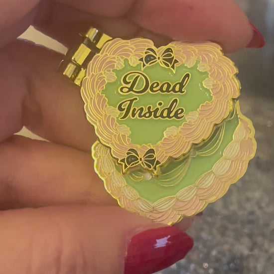 Moving enamel pin with cake halloween-themed design