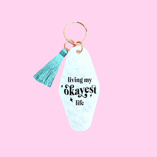 Living My Okayest Life White Swirled Keychain With Teal Tassel